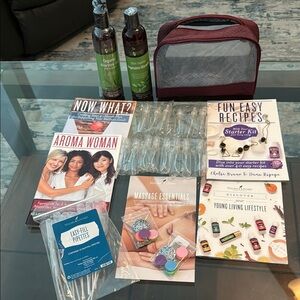 Young Living Essential Oils lot with jewelry, recipes, and travel case.